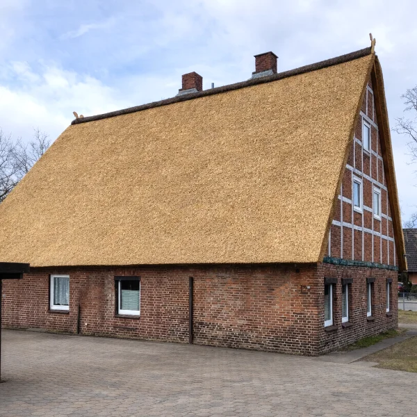 Thatched-roof brick farmhouse