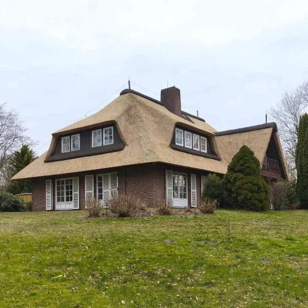 Large House with Reed Thatched Roof and Dormer Windows