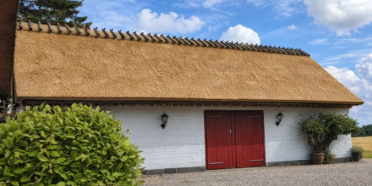 Traditional Reed Thatched Roof on White Brick Building